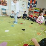 Chłopiec pokonuje tor przeszkód stworzony z włóczki na wzór pajęczyny