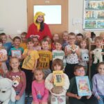 Kubuś Puchatek wraz z grupą przedszkolaków z grupy Mrówek pozują do zdjęcia.