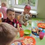 Stół ze słodkim poczęstunkiem dla dzieci w przedszkolnej sali